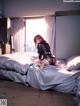 A woman sitting on top of a bed in a bedroom.