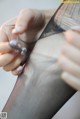 A close up of a person's hands holding a piece of fabric.