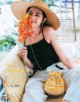 A woman sitting on a swing holding a bouquet of flowers.